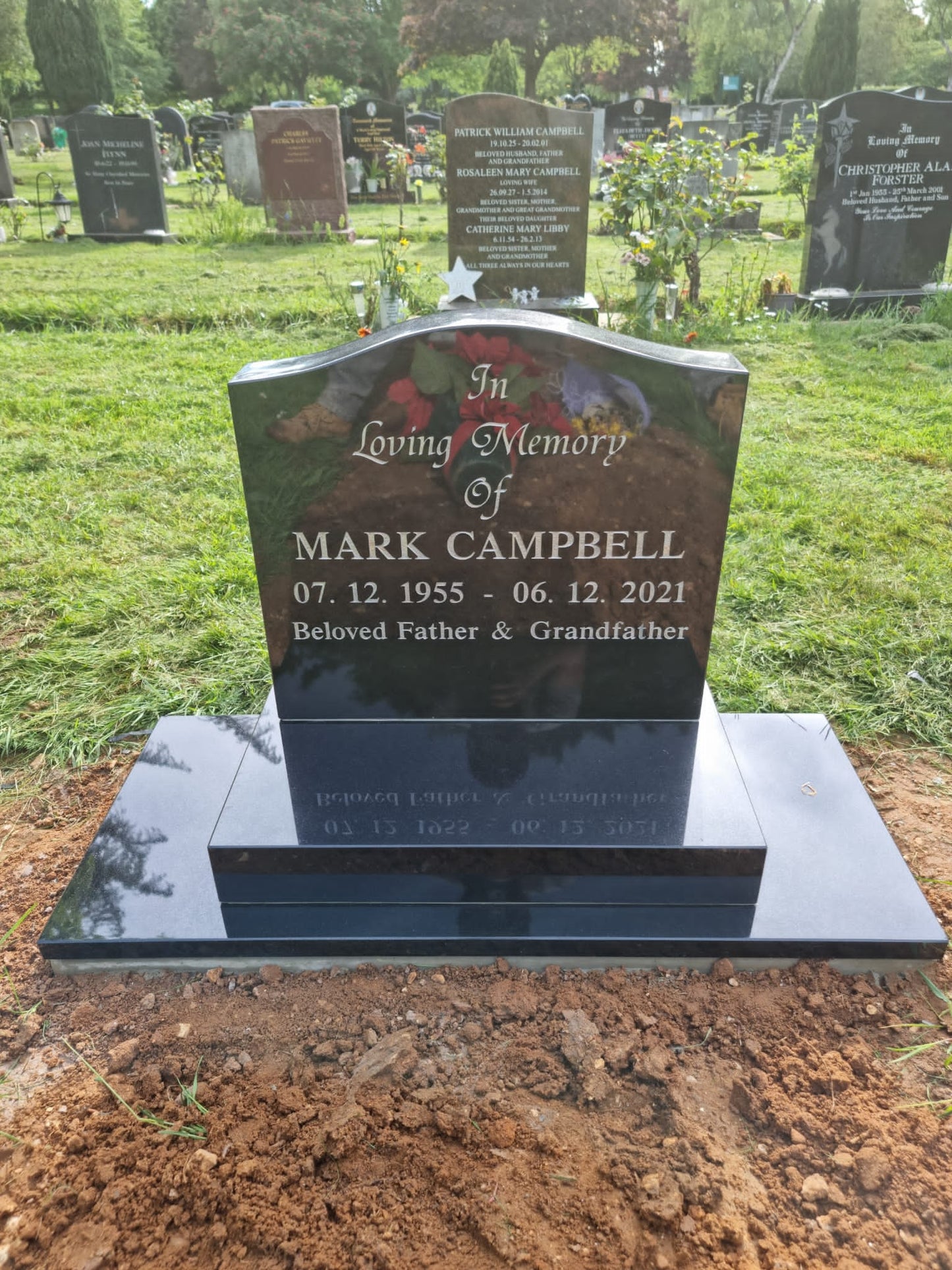 Oval Top Headstone Behind Desk Tablet