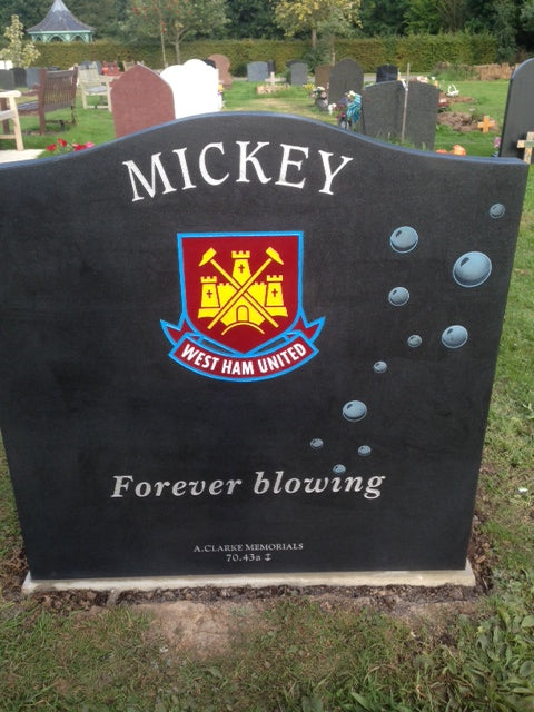 Ogee shaped memorial with scarf and football to base