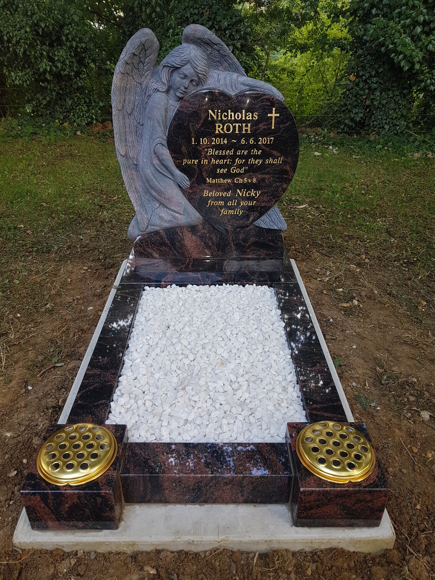 Carved Angel Leaning Over Heart Shaped Memorial