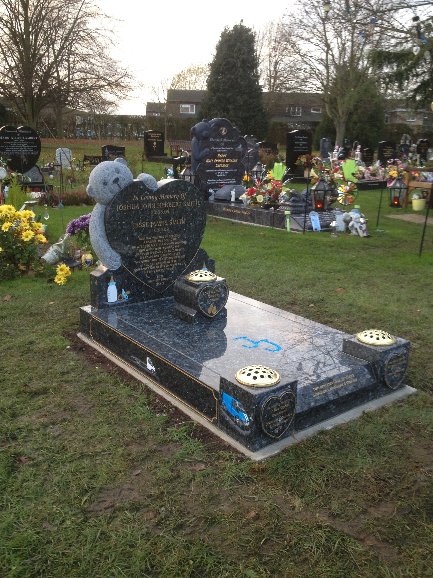 Double arch memorial with kerbs to match