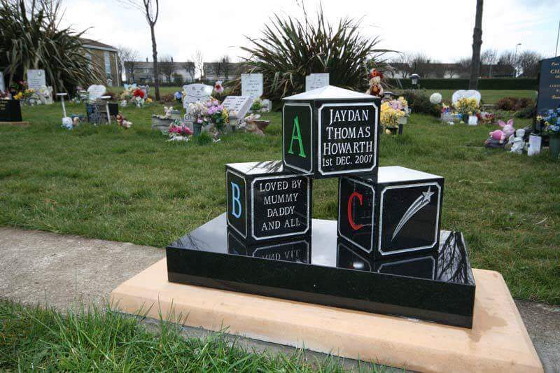 Double arch memorial with kerbs to match