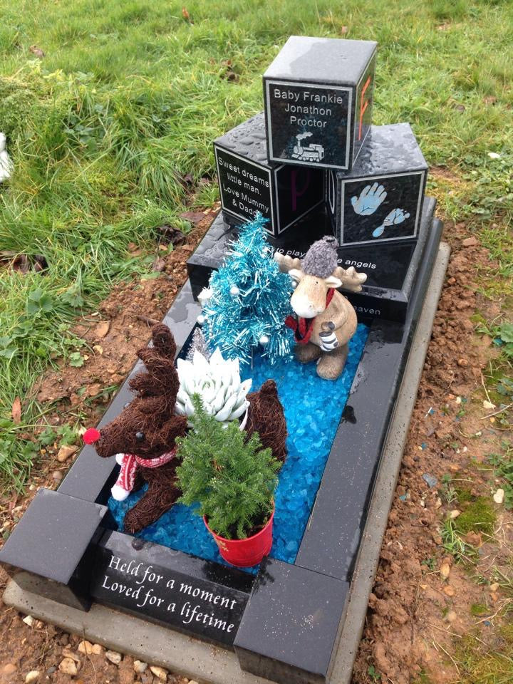 Double arch memorial with kerbs to match