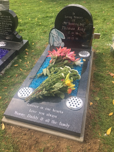 Double arch memorial with kerbs to match