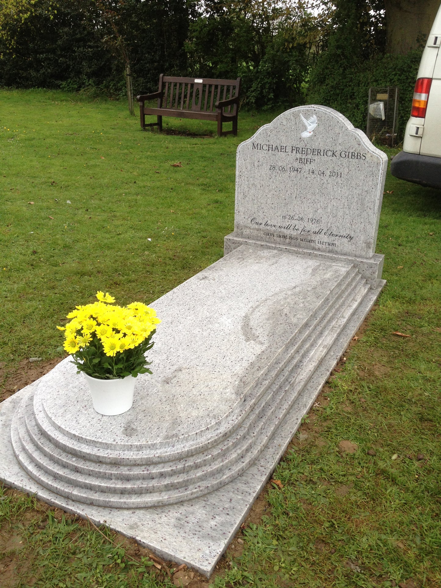 Round top memorial with tiered kerbs and cover slab