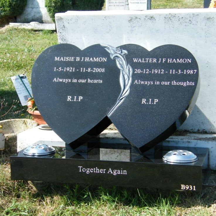 Double heart memorial with carved lily to centre