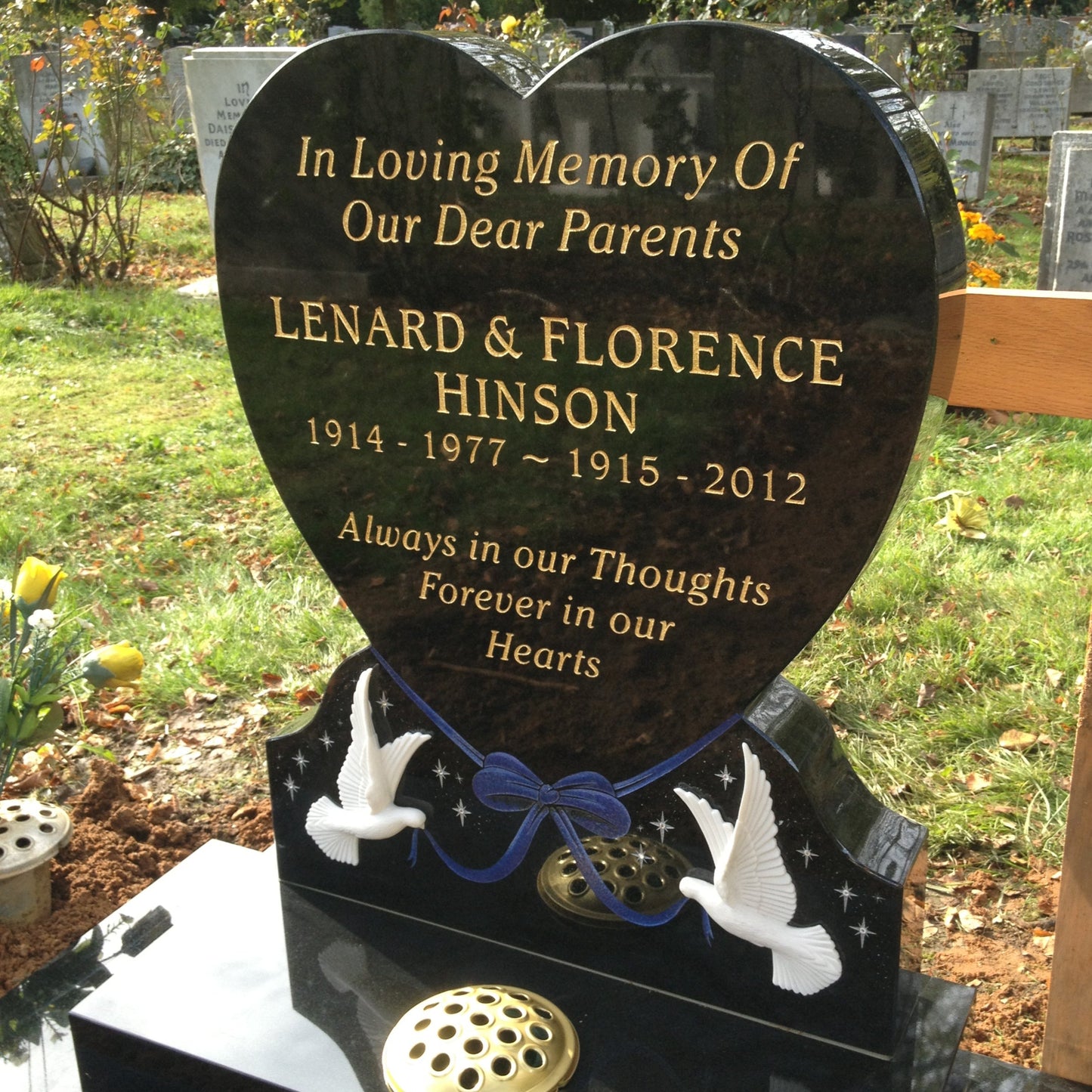 Heart memorial with carved roses to to both sides