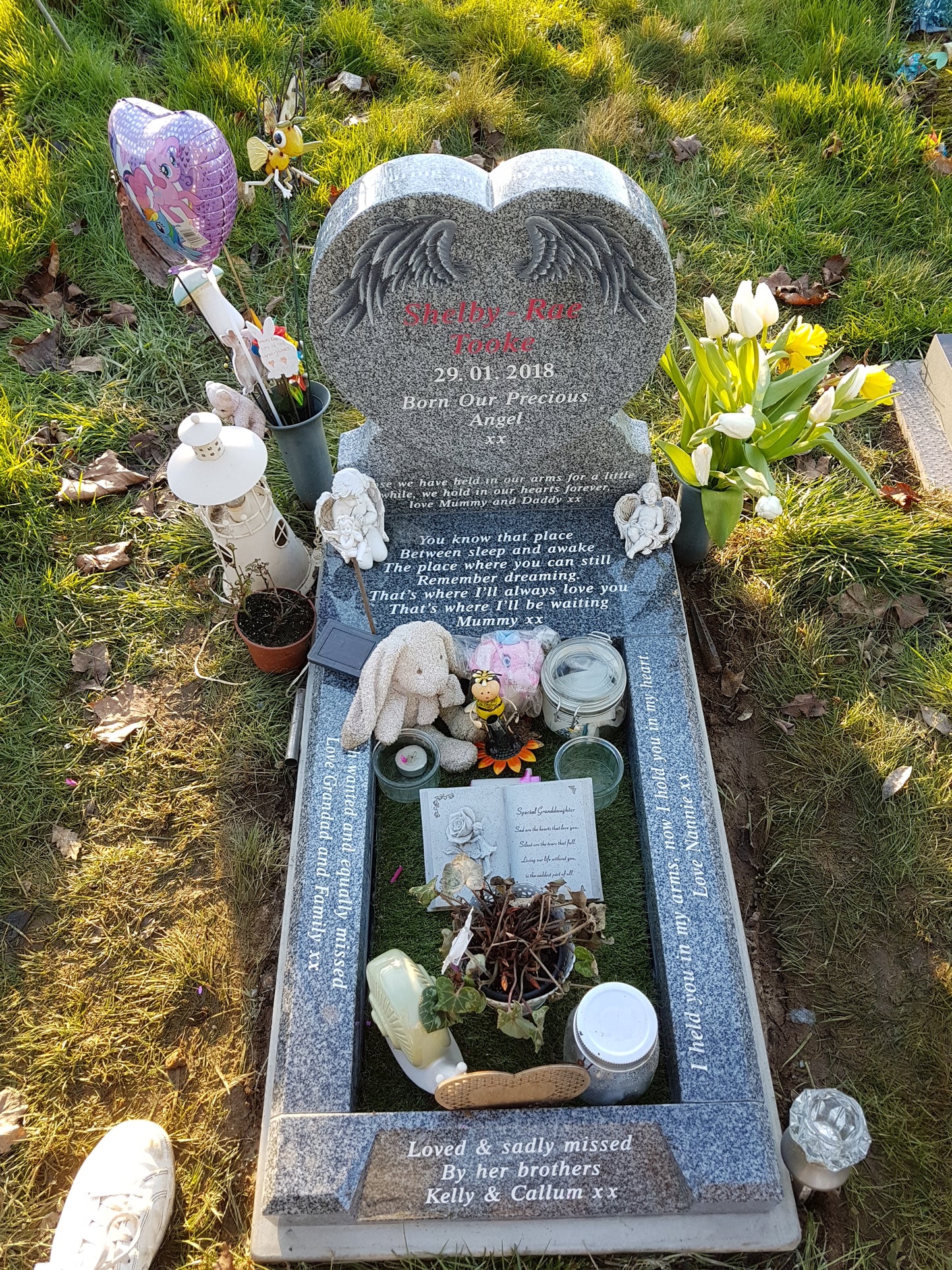 Double arch memorial with kerbs to match