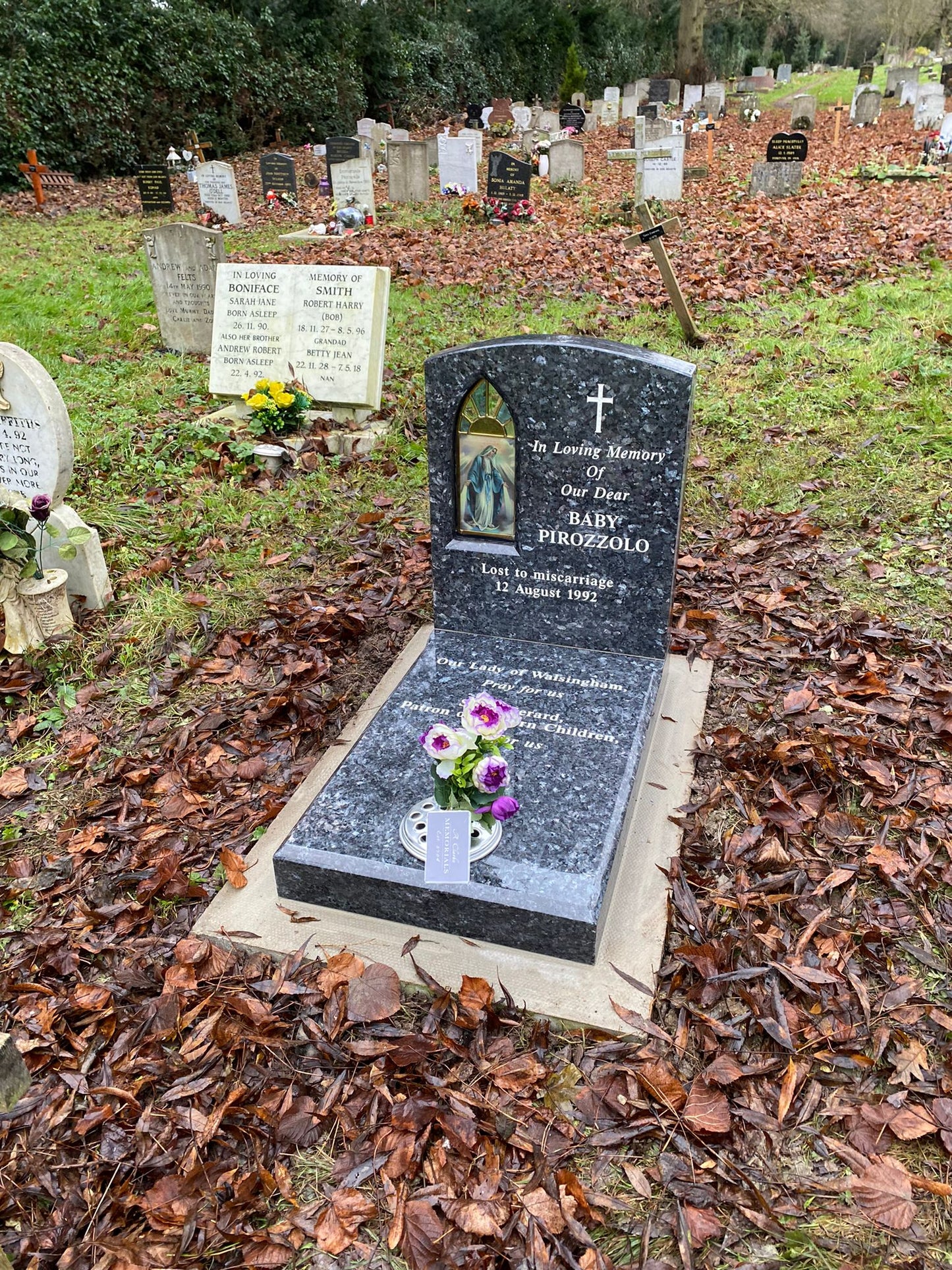 Double arch memorial with kerbs to match