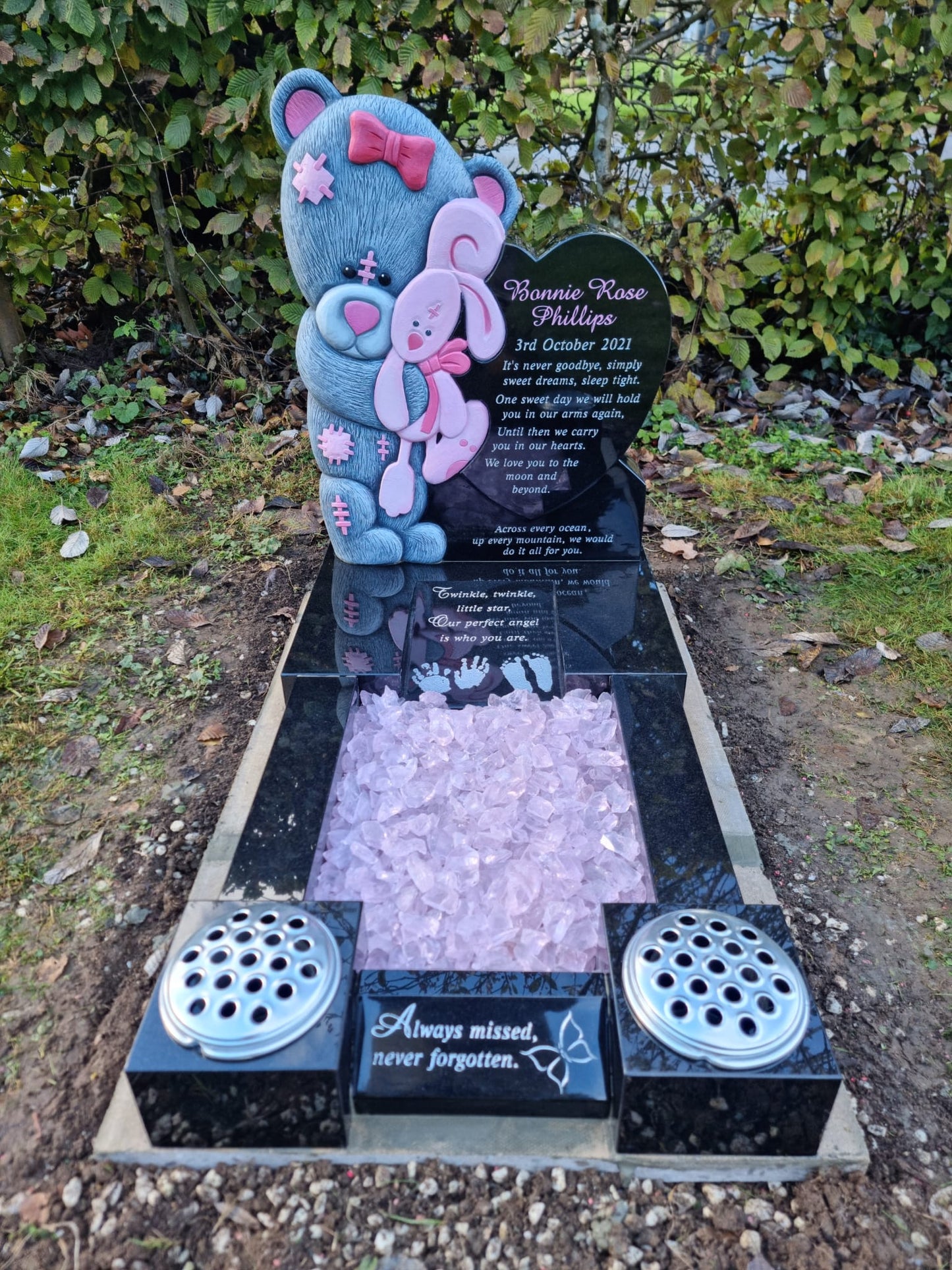 Teddy bear & blanket memorial with round top and square base.