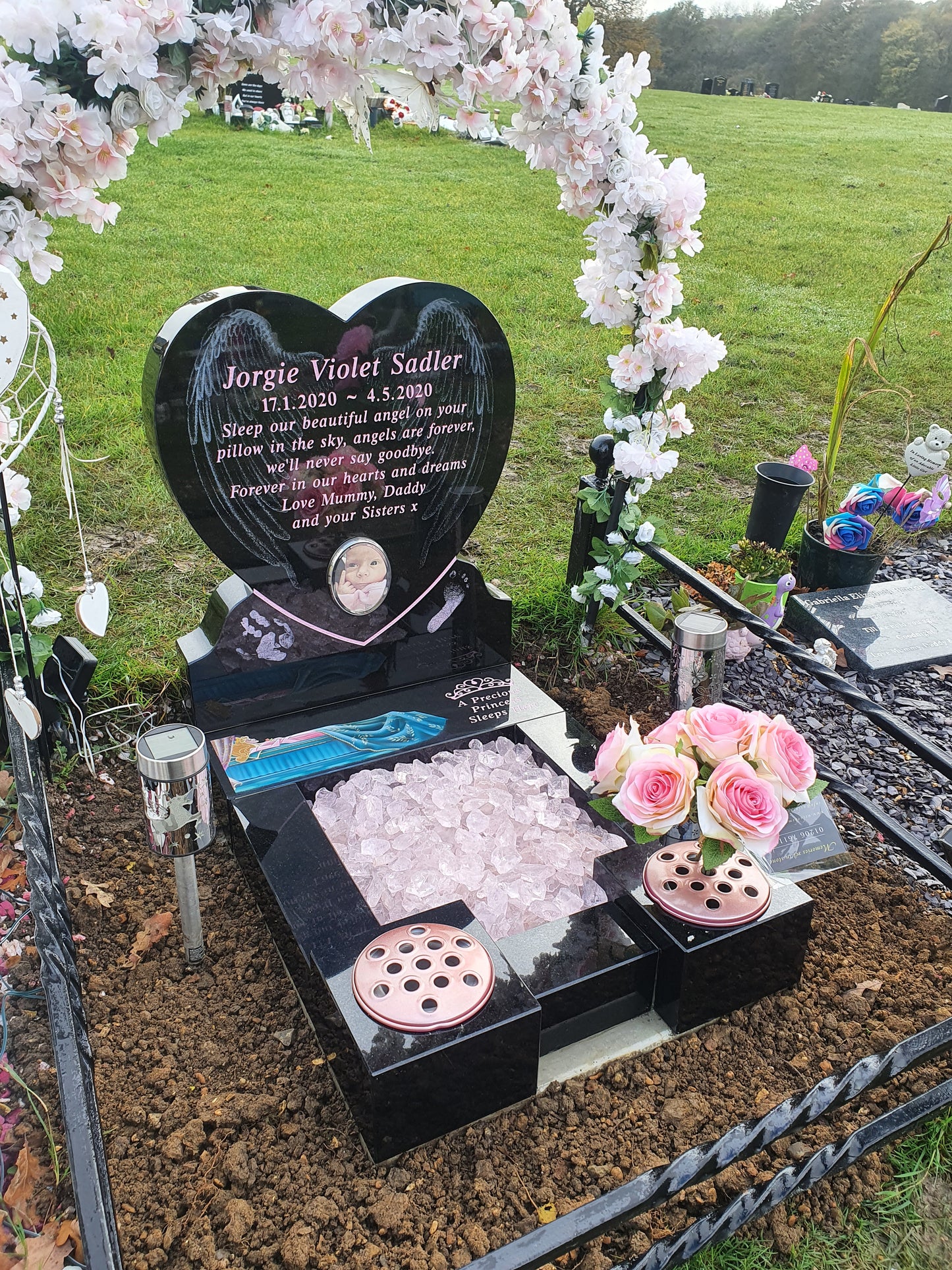 Double arch memorial with kerbs to match