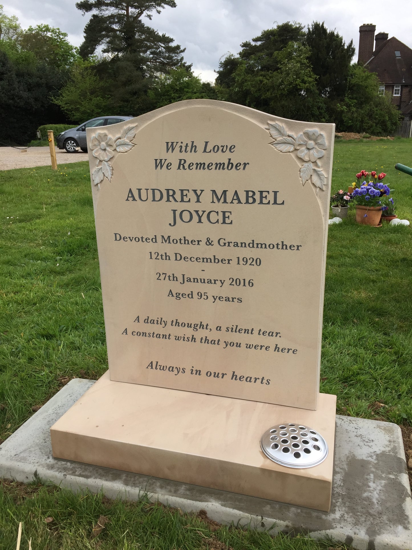 Oval Top Headstone With Scotia Shoulders And Rose Design