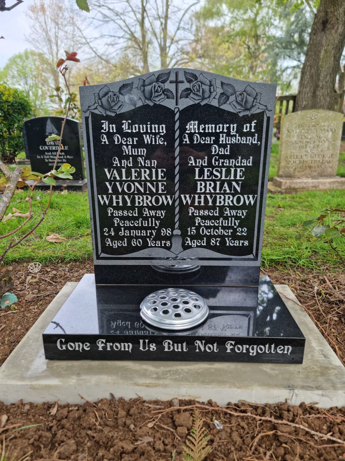 Carved panel memorial with carved cross and roses