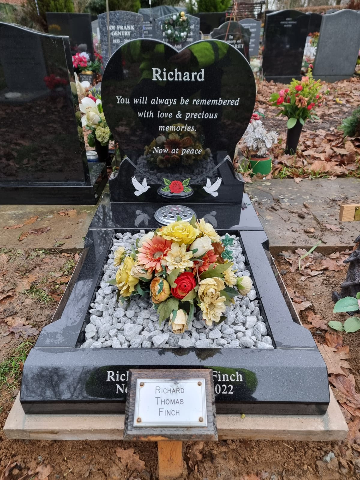 Heart memorial with carved roses to to both sides