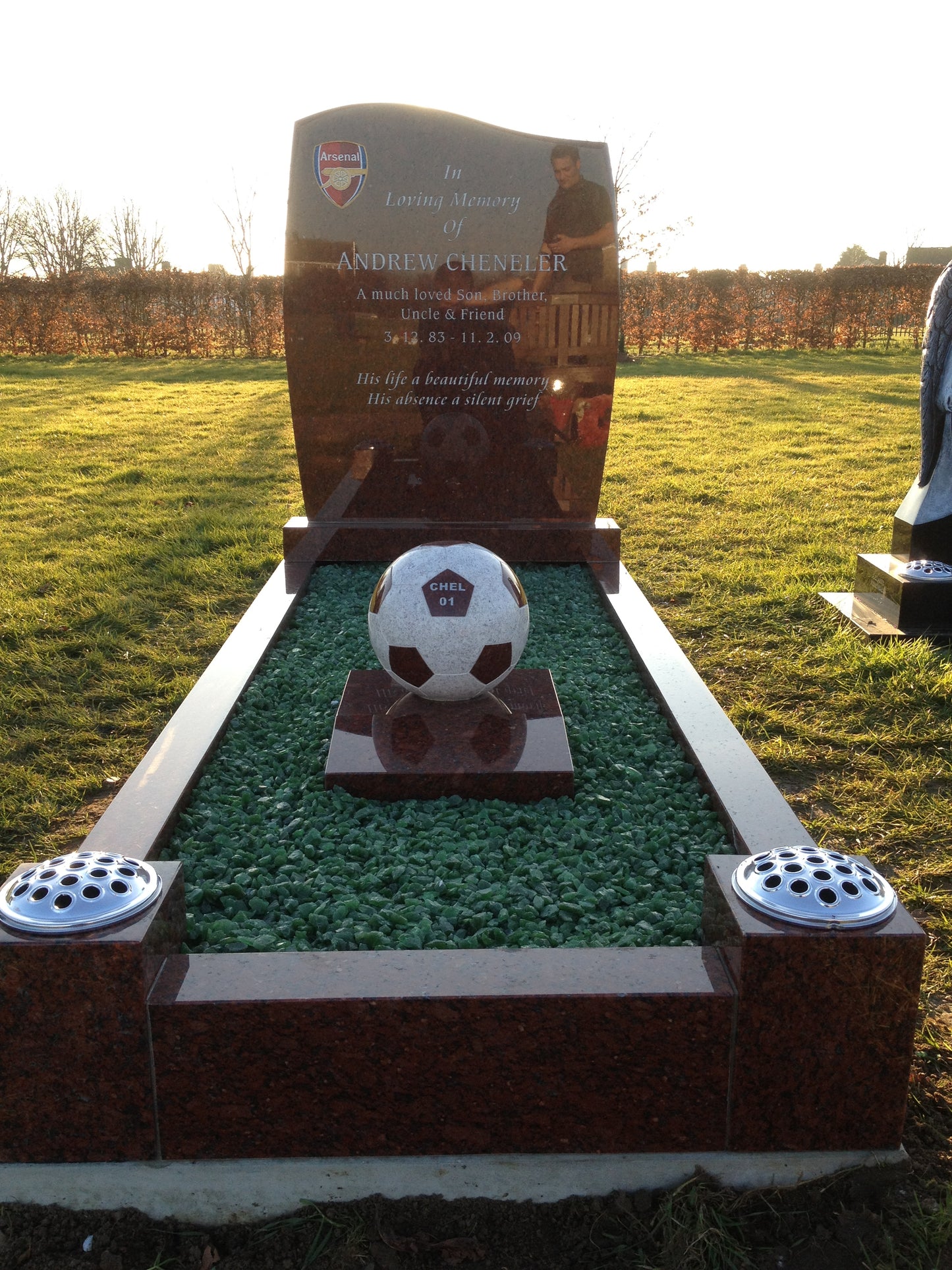 Ogee shaped memorial with scarf and football to base