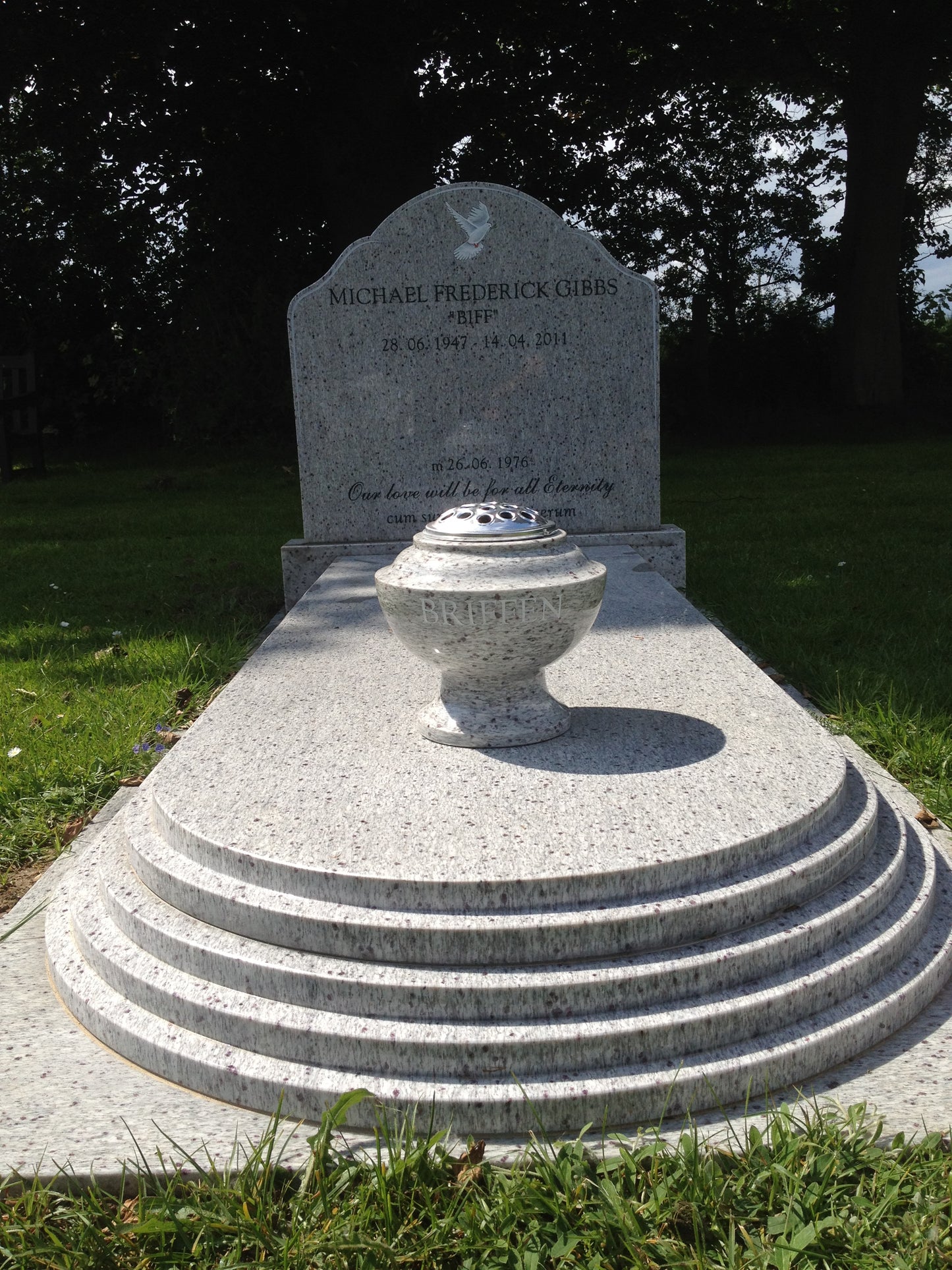 Round top memorial with tiered kerbs and cover slab