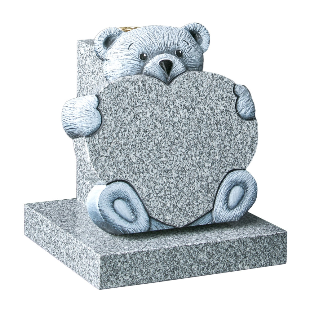 Carved teddy bear holding heart memorial with vase to rear