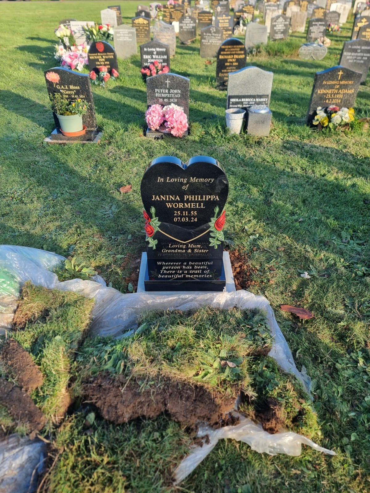 Heart shaped memorial with ogee front base and carved wild roses