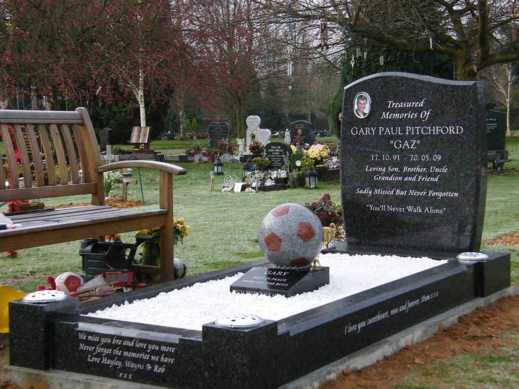 Ogee shaped memorial with scarf and football to base