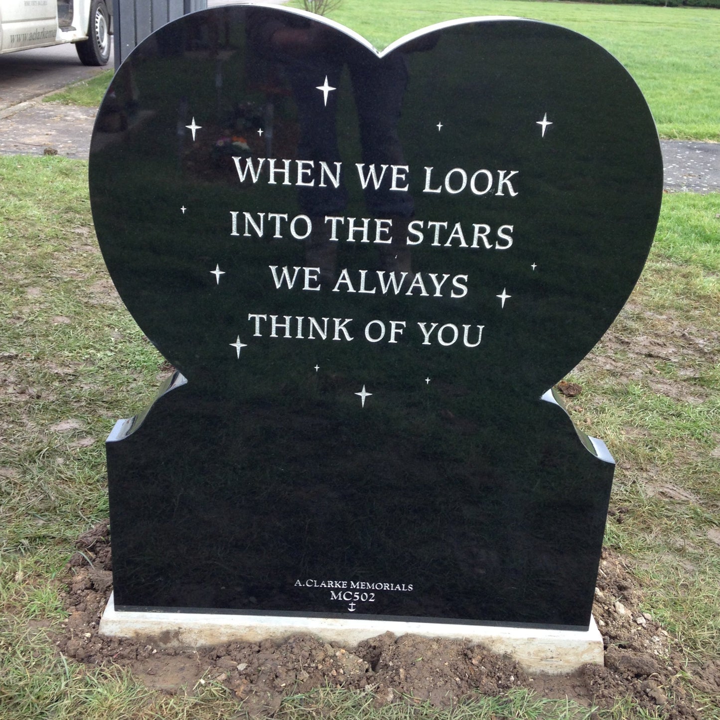 Heart shaped headstone with curved foot kerb and raised heart