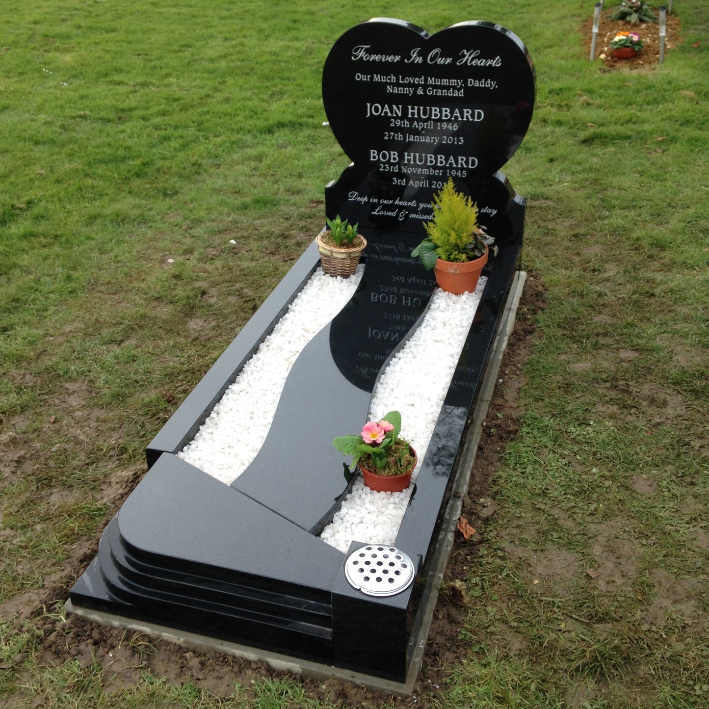 Heart shaped headstone with cover slab to kerbs