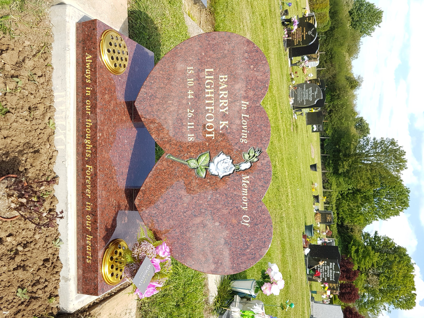 Heart shaped memorial with ogee front base and carved wild roses