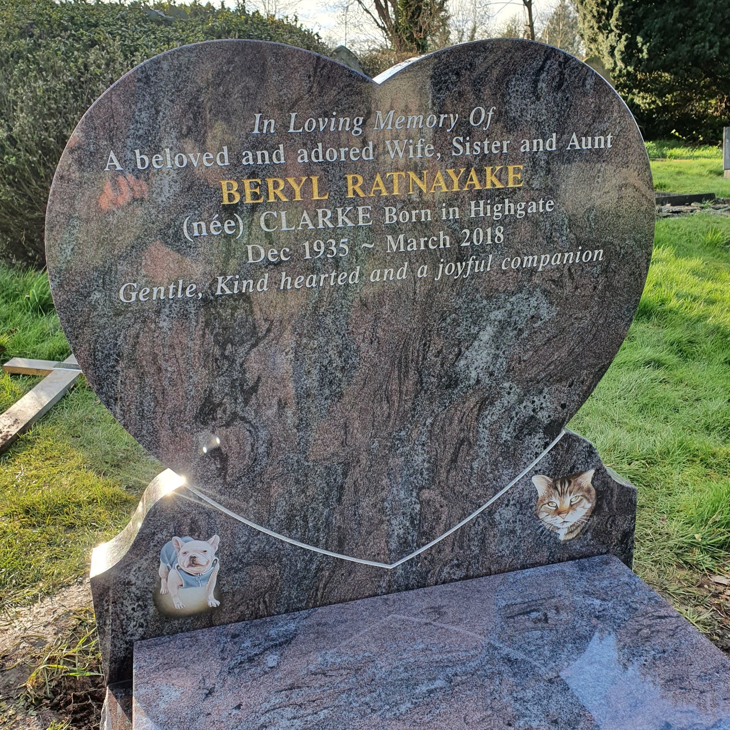 Heart shaped headstone with curved foot kerb and raised heart
