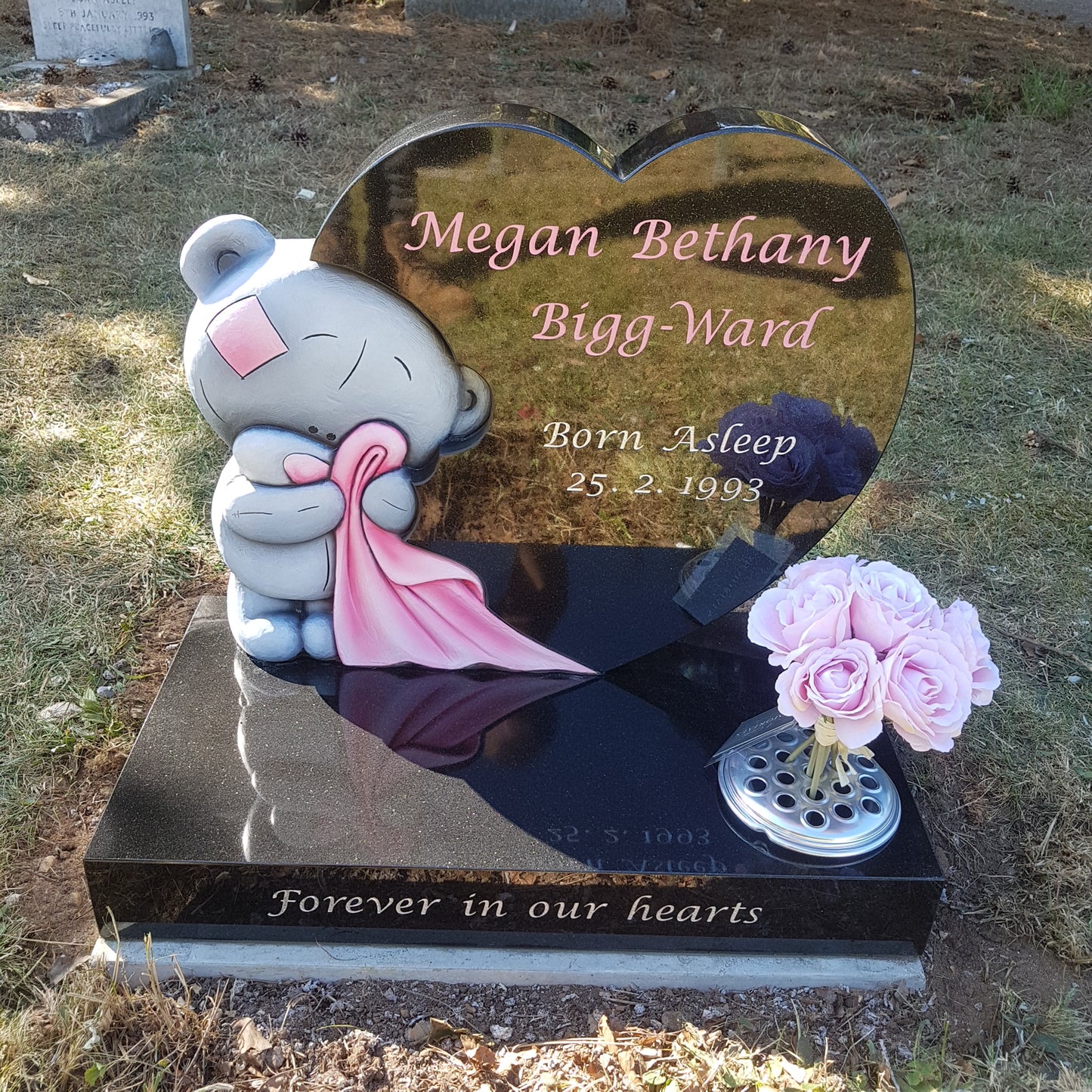 Teddy bear & blanket memorial with round top and square base.