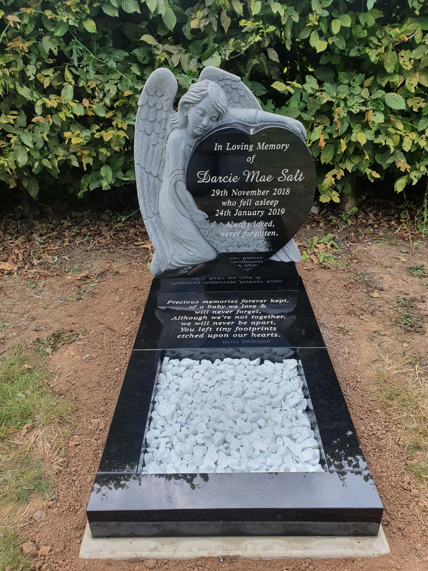 Carved Angel Leaning Over Heart Shaped Memorial